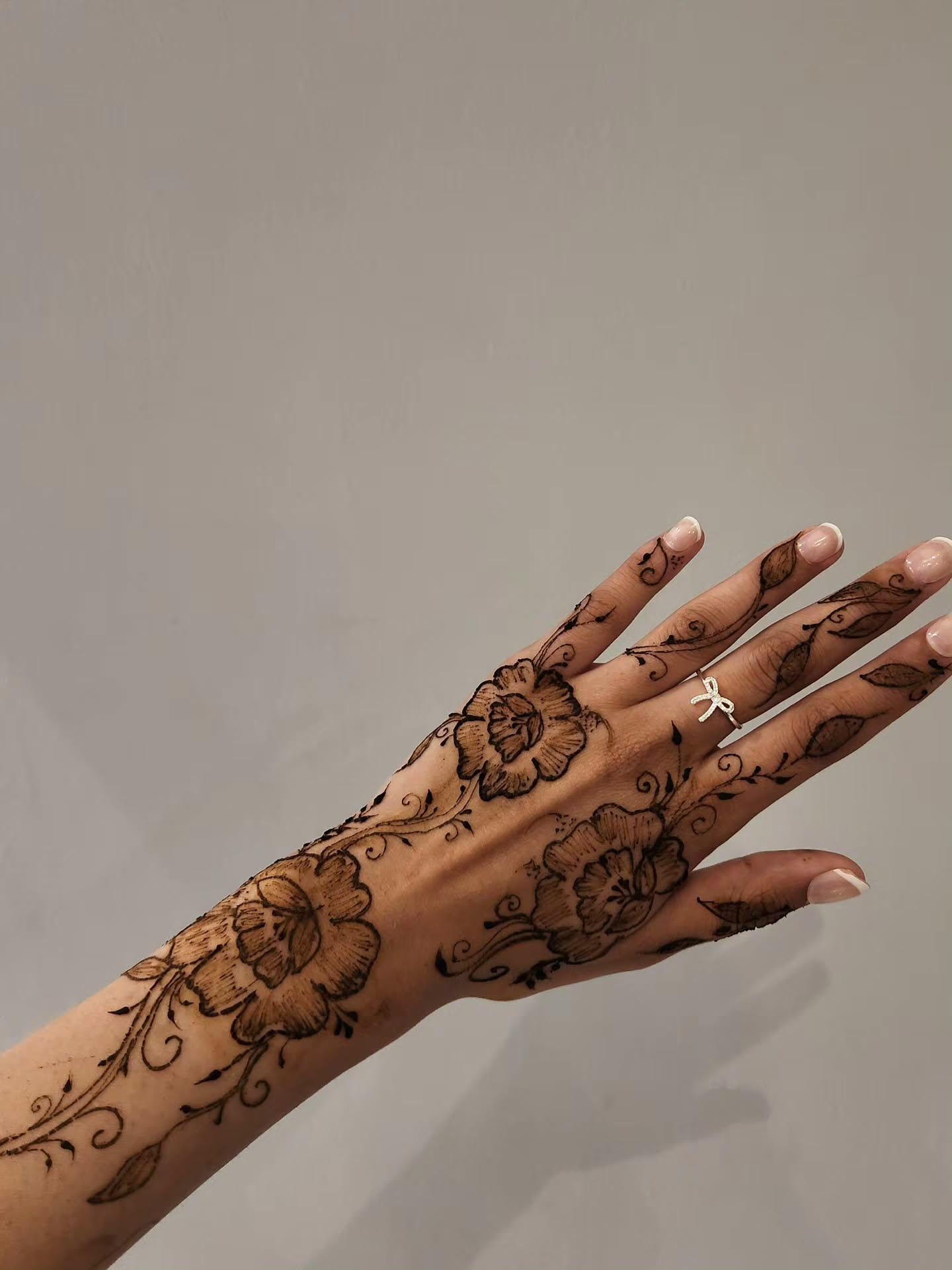 Floral henna on the back of the hand