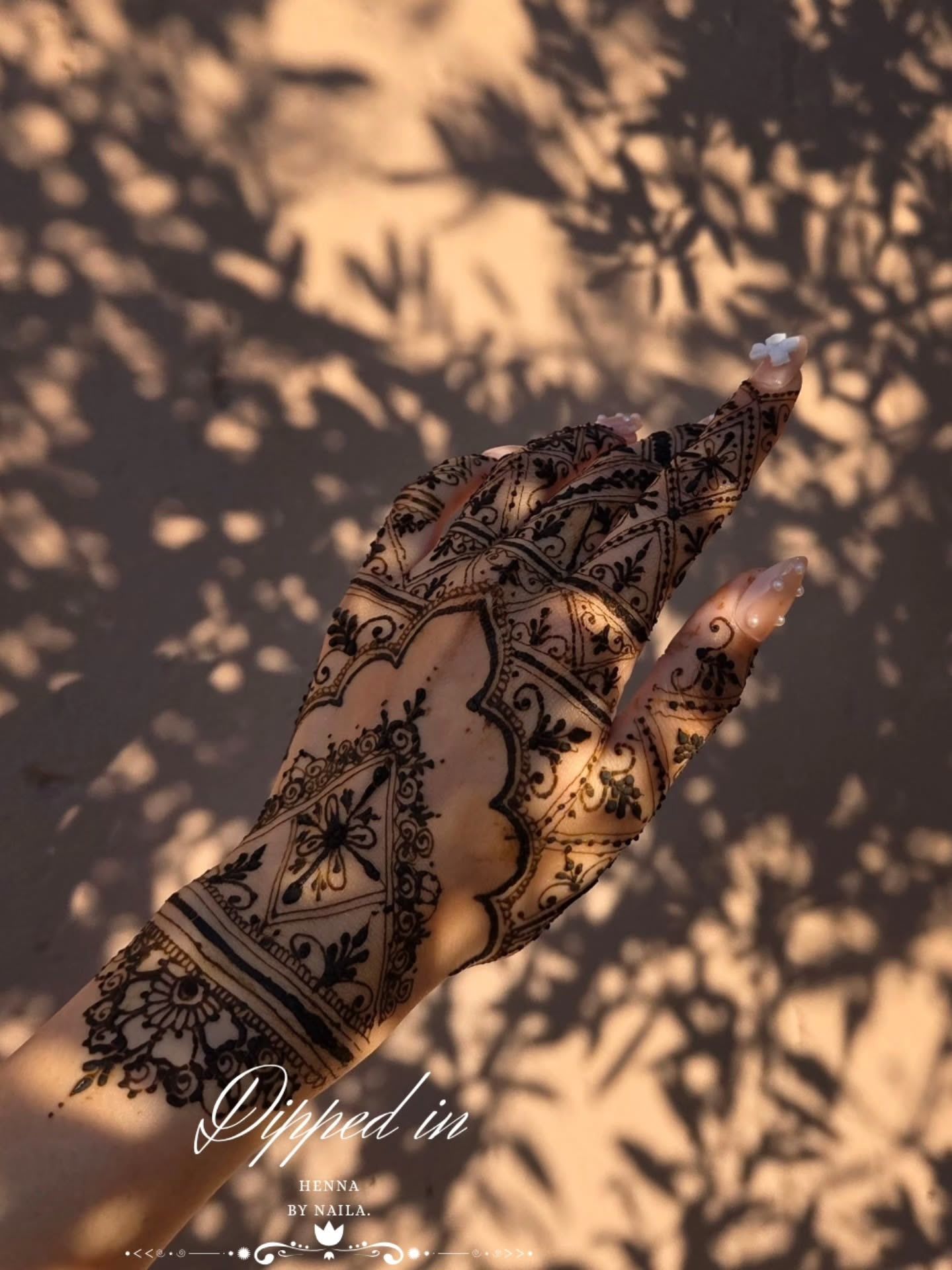 Detailed henna on the back of the hand in sunlight and shadow