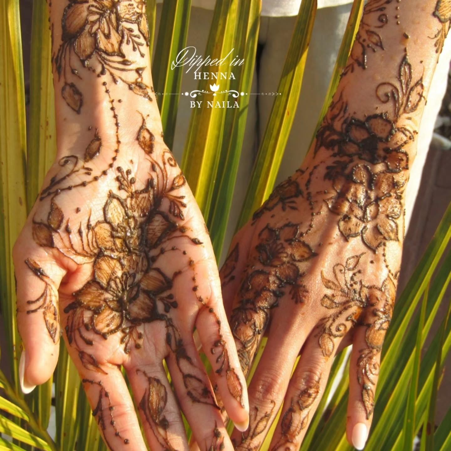 Two palms with matching henna designs